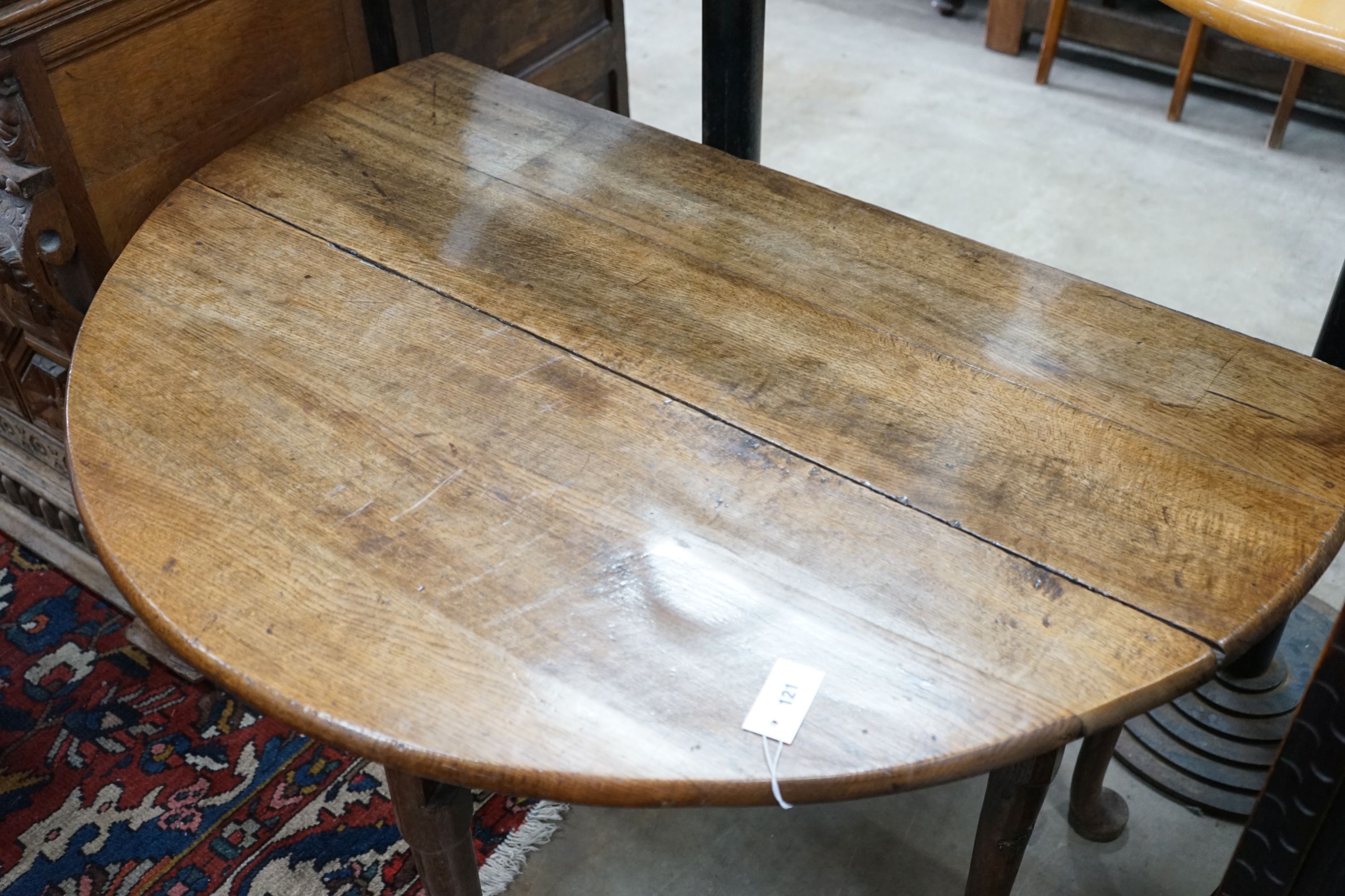 A George III provincial oak drop leaf pad foot dining table, length 120cm extended, width 120cm, height 72cm